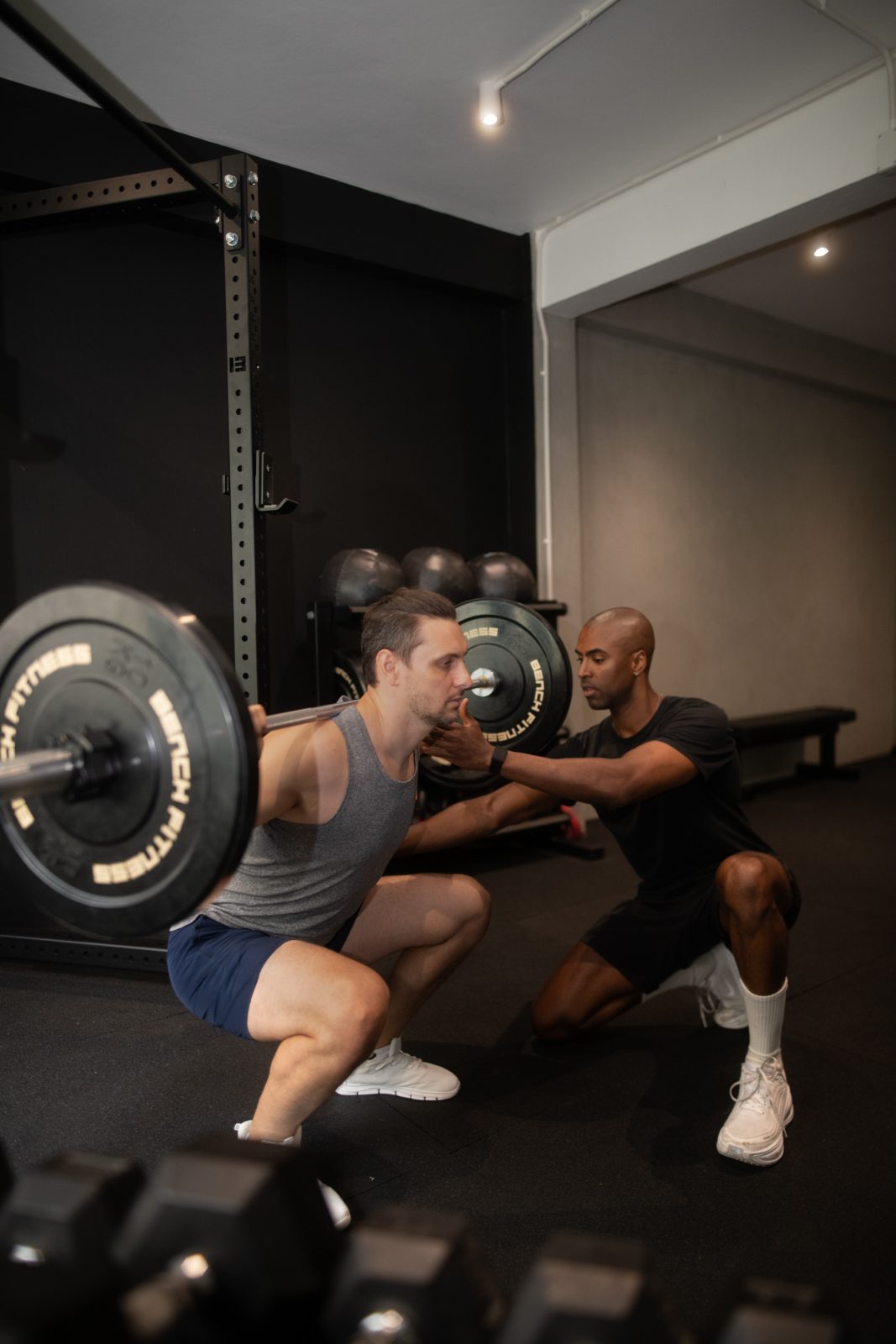 Jonathan Colorado coaching a client on a lat pulldown in a private New York studio