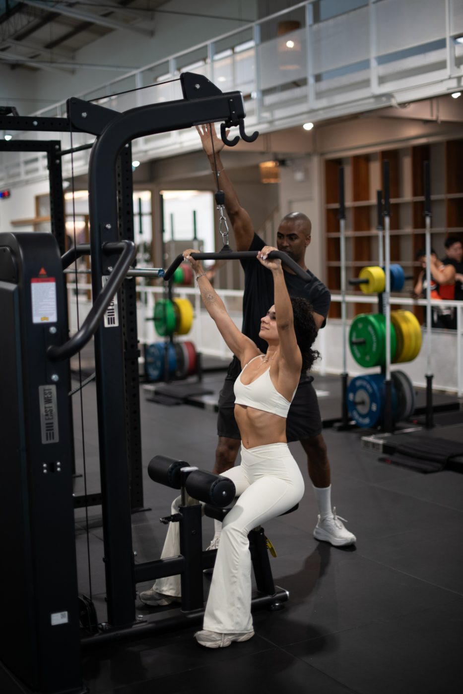 NYC personal trainer coaching a client through a lat pulldown